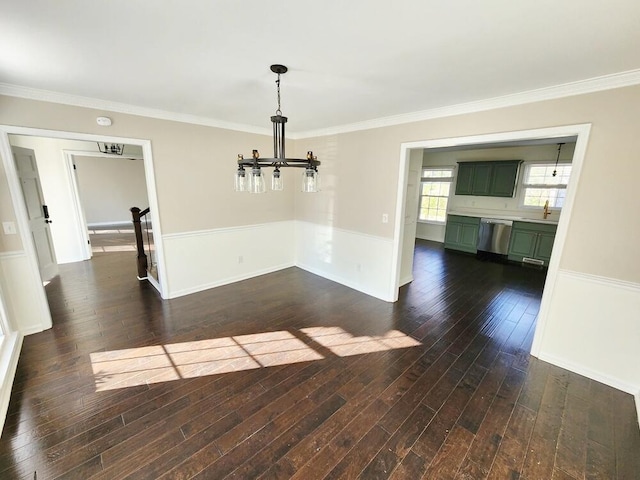 unfurnished dining area featuring dark hardwood / wood-style flooring, ornamental molding, and sink