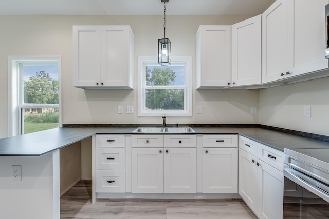 306 S Magnolia Ave, Andrews, SC 29510 - kitchen featuring a sink, white cabinets, plenty of natural light, and hanging light fixtures