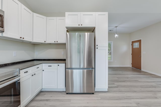 306 S Magnolia Ave, Andrews, SC 29510 - kitchen featuring stainless steel appliances, light wood-type flooring, and white cabinetry
