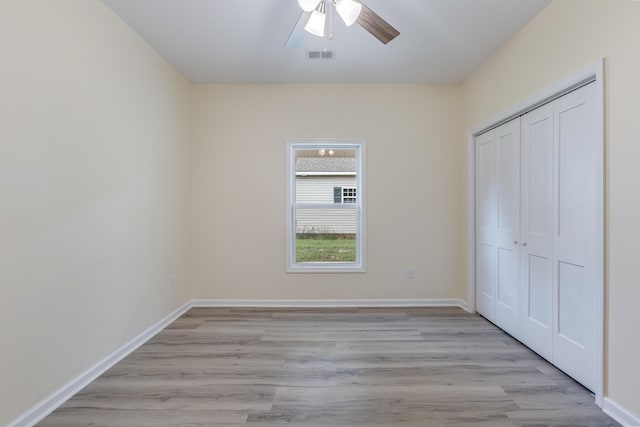 306 S Magnolia Ave, Andrews, SC 29510 - unfurnished bedroom featuring light wood-style floors, a closet, baseboards, and a ceiling fan