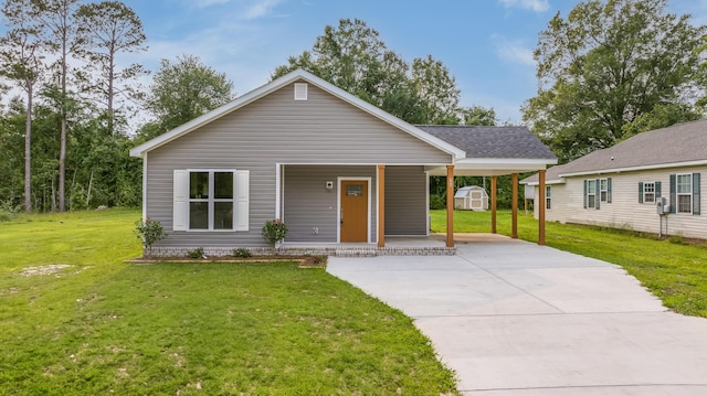 306 S Magnolia Ave, Andrews, SC 29510 - view of front facade with covered porch, concrete driveway, a front yard, and an attached carport