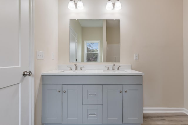 306 S Magnolia Ave, Andrews, SC 29510 - bathroom with double vanity, wood finished floors, and baseboards