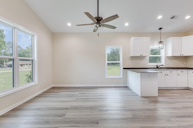306 S Magnolia Ave, Andrews, SC 29510 - kitchen featuring dark countertops, a sink, light wood finished floors, and recessed lighting