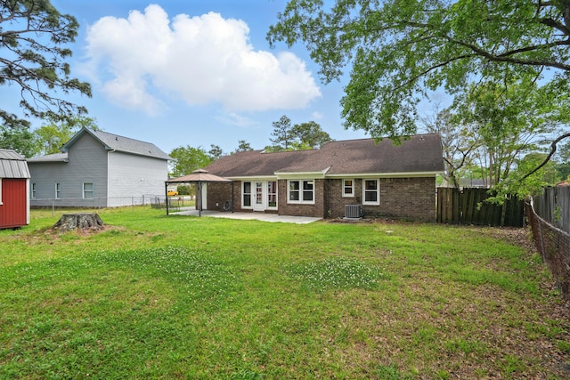 106 Ruffin Rd, Summerville, SC 29486 - rear view of house with central air condition unit, a fenced backyard, a lawn, a patio, and a gazebo