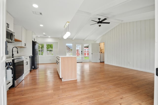 106 Ruffin Rd, Summerville, SC 29486 - kitchen featuring light wood-type flooring, lofted ceiling with beams, light countertops, and stainless steel appliances