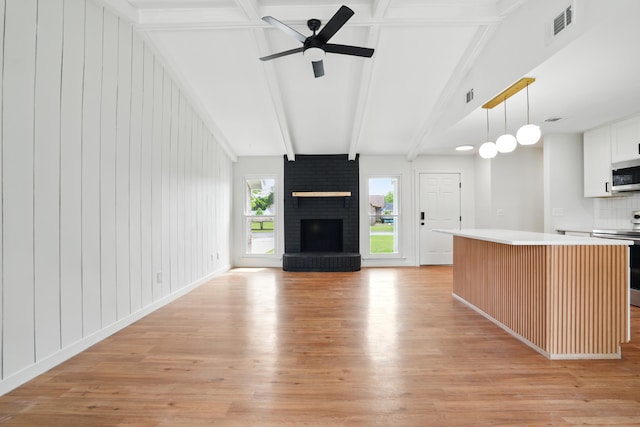 106 Ruffin Rd, Summerville, SC 29486 - unfurnished living room with a fireplace, a ceiling fan, visible vents, beamed ceiling, and light wood finished floors