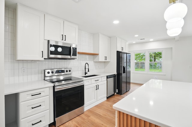 106 Ruffin Rd, Summerville, SC 29486 - kitchen featuring light wood-style flooring, light countertops, decorative backsplash, stainless steel appliances, and a sink