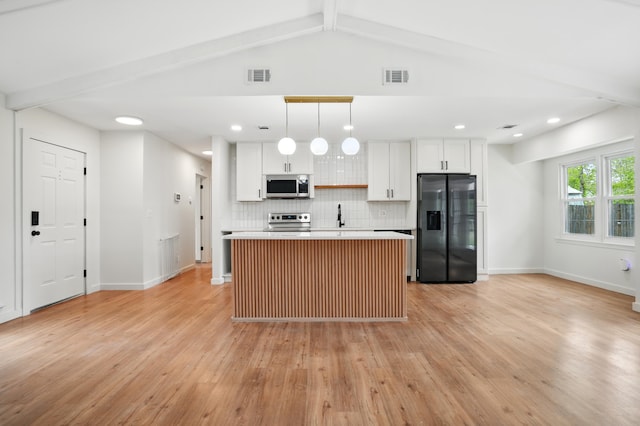 106 Ruffin Rd, Summerville, SC 29486 - kitchen with tasteful backsplash, visible vents, appliances with stainless steel finishes, and a kitchen island