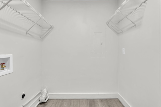 laundry area featuring electric panel, hookup for a washing machine, hardwood / wood-style floors, and electric dryer hookup