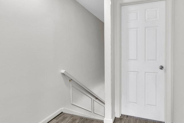 stairs featuring hardwood / wood-style floors