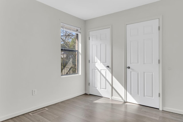 unfurnished bedroom with light wood-type flooring