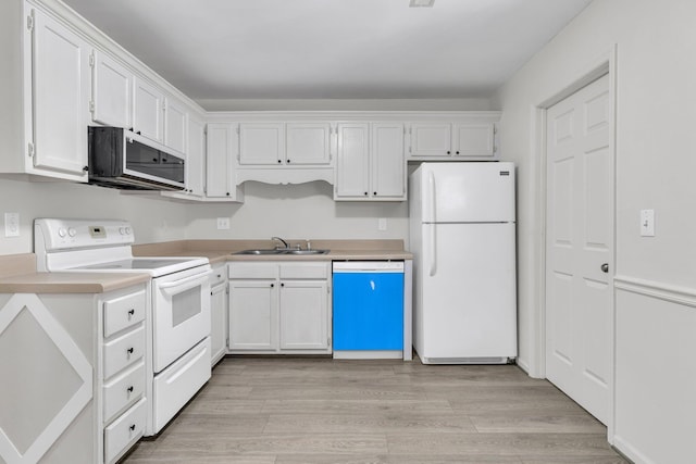 kitchen with white cabinetry, sink, white appliances, and light hardwood / wood-style floors