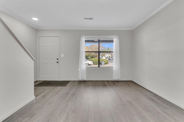 foyer with crown molding and light wood-type flooring