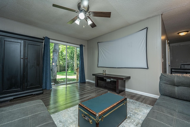 interior space featuring a textured ceiling, ceiling fan, and dark wood-type flooring