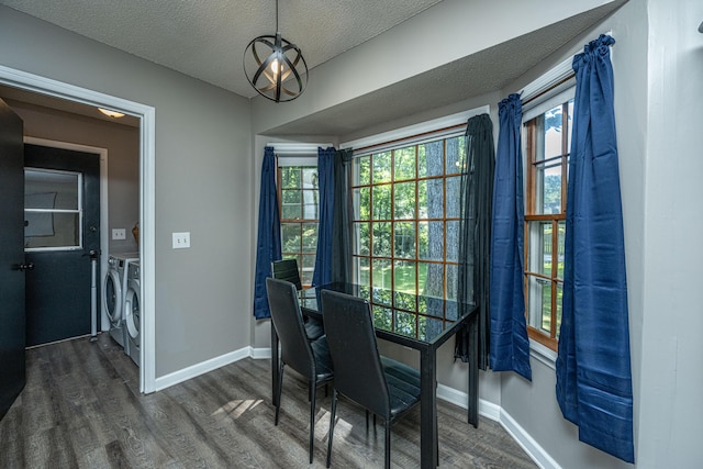 dining room with a textured ceiling, dark hardwood / wood-style floors, and independent washer and dryer