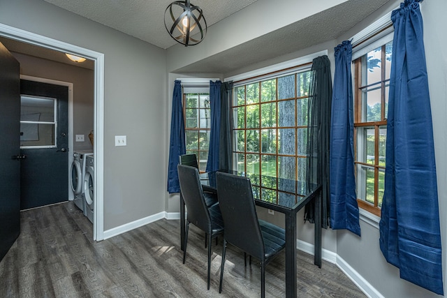 dining space featuring dark hardwood / wood-style floors, a textured ceiling, and washing machine and clothes dryer