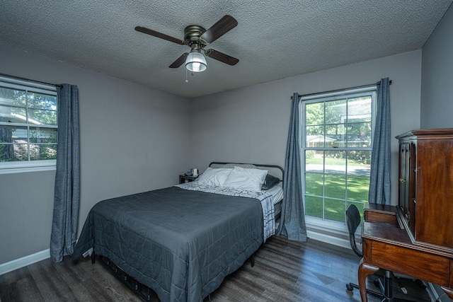 bedroom featuring ceiling fan, dark hardwood / wood-style flooring, and a textured ceiling