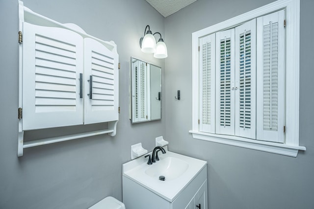 bathroom featuring a textured ceiling and vanity