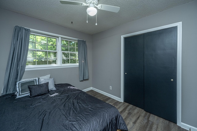 bedroom featuring a textured ceiling, a closet, hardwood / wood-style flooring, and ceiling fan