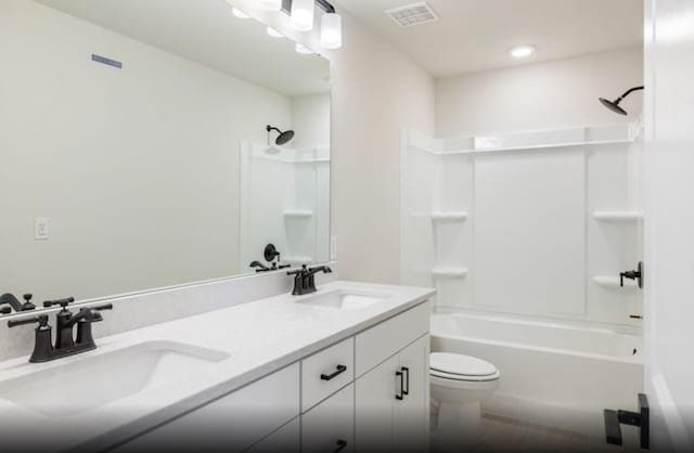 full bathroom featuring shower / bathing tub combination, vanity, and toilet