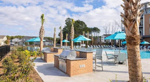 surrounding community with area for grilling, fence, a pool, a patio, and a residential view