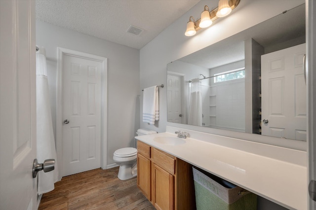 1219 Bradley Blvd, Summerville, SC 29486 - full bathroom featuring wood finished floors, toilet, a shower with curtain, vanity, and a textured ceiling