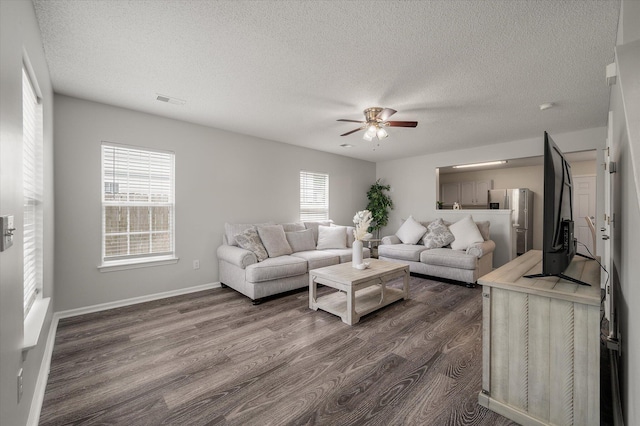 1219 Bradley Blvd, Summerville, SC 29486 - living room featuring a ceiling fan, dark wood-style flooring, a textured ceiling, and baseboards