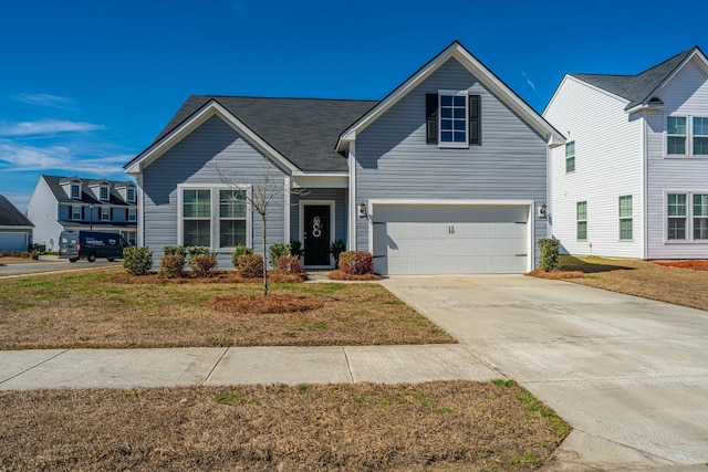 traditional home featuring a garage, driveway, and a front yard