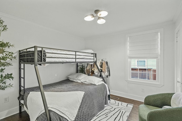 bedroom with dark wood-type flooring and crown molding