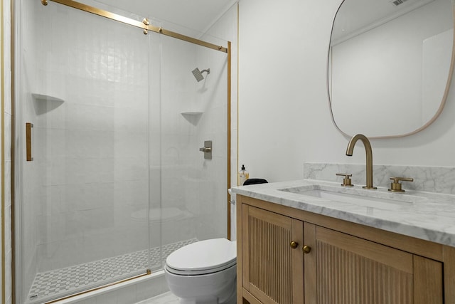 bathroom featuring toilet, vanity, and an enclosed shower