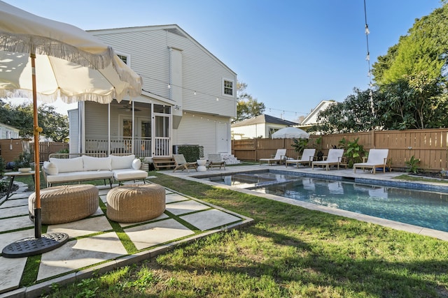 view of pool with an outdoor hangout area, a patio area, a yard, and a sunroom