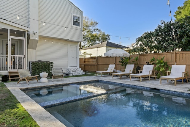 view of swimming pool featuring a patio and an in ground hot tub