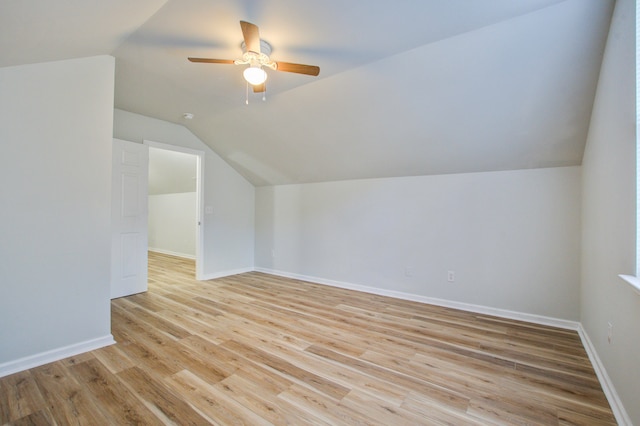 additional living space with vaulted ceiling, light hardwood / wood-style flooring, and ceiling fan