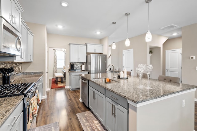 413 Ribiero Dr, Summerville, SC 29486 - kitchen with visible vents, a sink, decorative backsplash, dark wood-type flooring, and appliances with stainless steel finishes