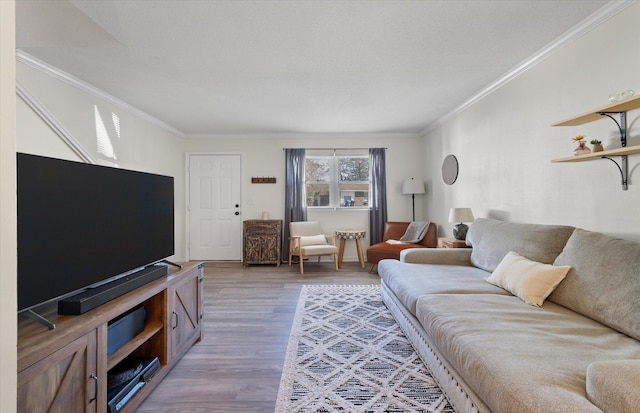 living room featuring crown molding and wood finished floors