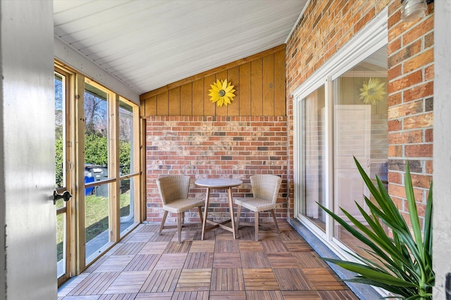 unfurnished sunroom with lofted ceiling