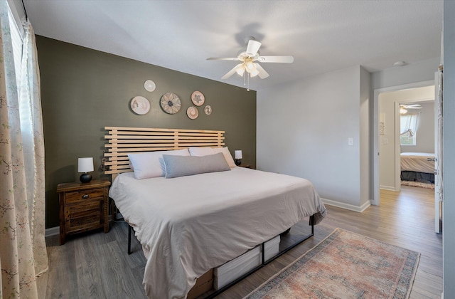 bedroom featuring wood finished floors, baseboards, and ceiling fan