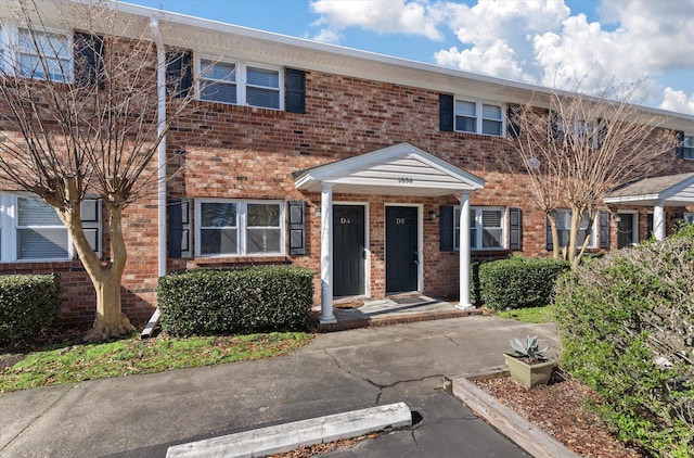 townhome / multi-family property featuring brick siding