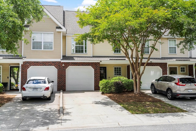 8676 Grassy Oak Trl, North Charleston, SC 29420 - multi unit property featuring an attached garage, driveway, a shingled roof, and brick siding