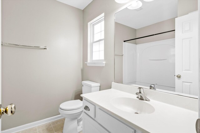 8676 Grassy Oak Trl, North Charleston, SC 29420 - bathroom with baseboards, toilet, vanity, and a shower