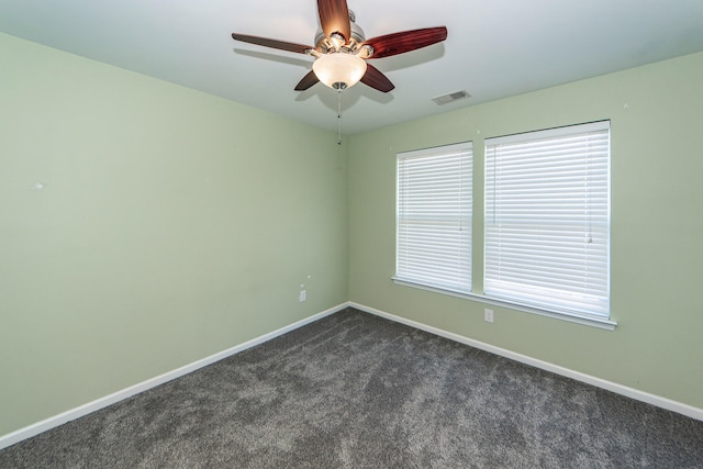 carpeted spare room featuring ceiling fan