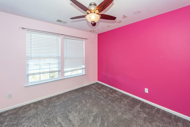 carpeted spare room featuring ceiling fan