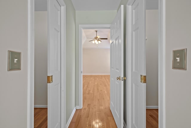 hallway with light wood-style floors and baseboards