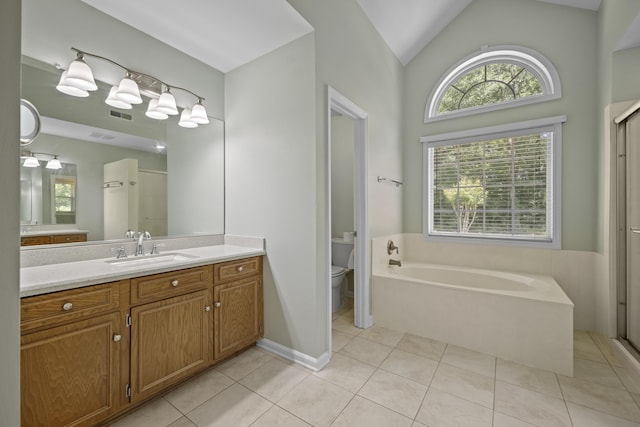 full bathroom featuring toilet, tile patterned floors, a stall shower, a garden tub, and vanity