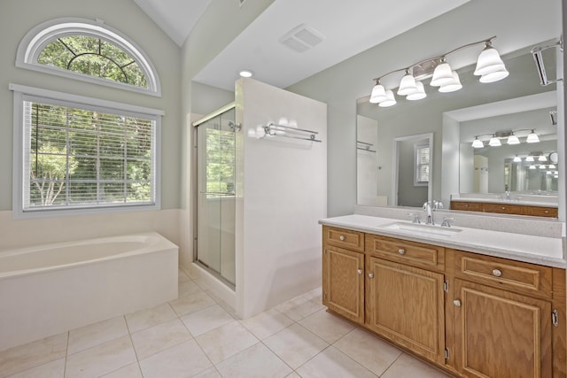 bathroom featuring healthy amount of natural light, a stall shower, tile patterned flooring, and vaulted ceiling