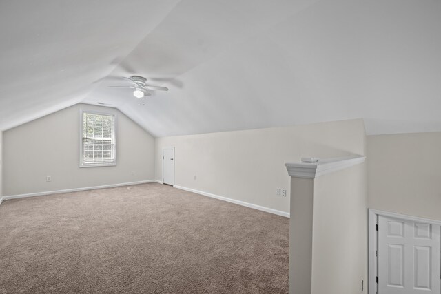 bonus room with ceiling fan, vaulted ceiling, carpet, and baseboards