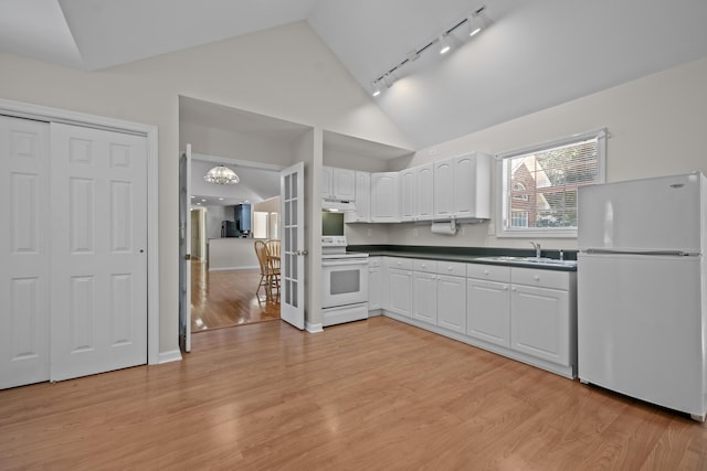 kitchen with white appliances, track lighting, a sink, under cabinet range hood, and white cabinetry
