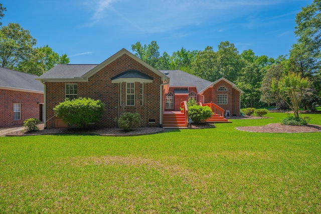 view of front of home with a front lawn and brick siding