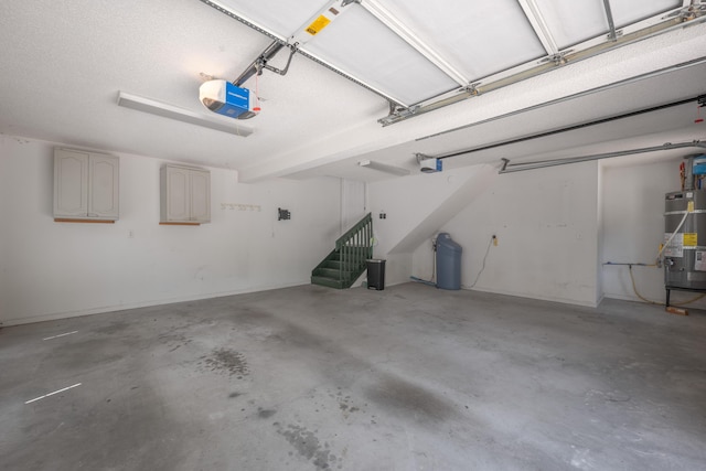 garage with water heater and a garage door opener