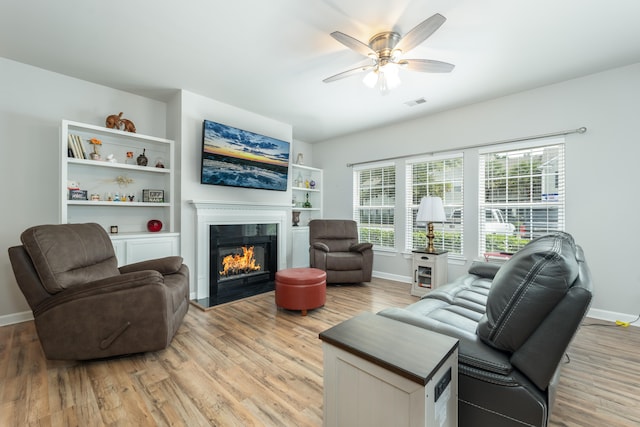 living room with ceiling fan and light hardwood / wood-style floors